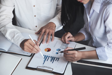 Two people reviewing business charts and data as part of setting up a business in DMCC Dubai.