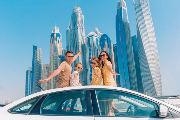 A family poses in front of Dubai skyscrapers, symbolizing potential residents understanding visa requirements.