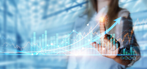 Businesswoman interacting with futuristic financial graphs, symbolizing DMCC Dubai's dynamic economic environment.