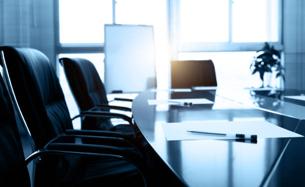 Modern conference room table with papers and pens, reflecting professional setting for discussing DMCC ideas.