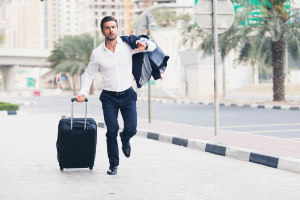 Businessman rushing with luggage in Dubai, indicating the urgency of securing a Dubai residence visa.